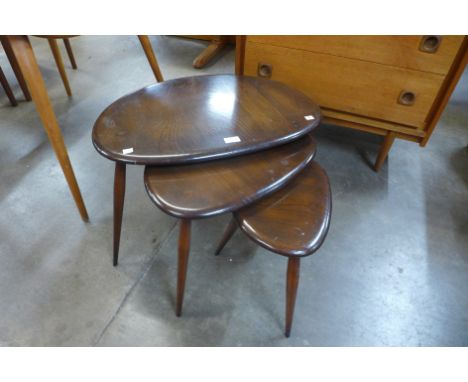 An Ercol dark elm and beech pebble shaped nest of tables 