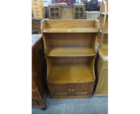 A small Ercol Golden Dawn elm and beech two door bookcase 