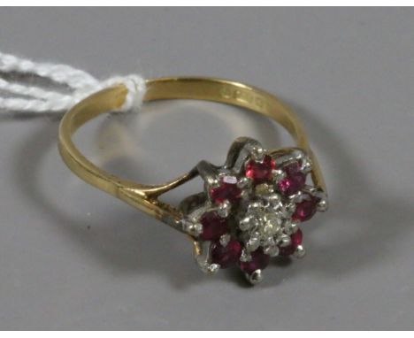 An 18ct gold ruby and diamond cluster ring size O.