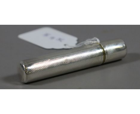 A circular cased silver lighter with engine turned decoration. No marks.