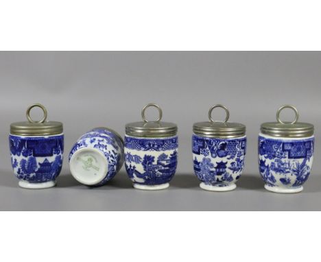 Five ceramic blue and white willow pattern egg coddlers to include Royal Worcester and Coalport examples.