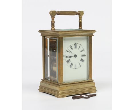 An early C20th French brass cased carriage clock with enamel dial twin train movement and striking half hourly on a gong.