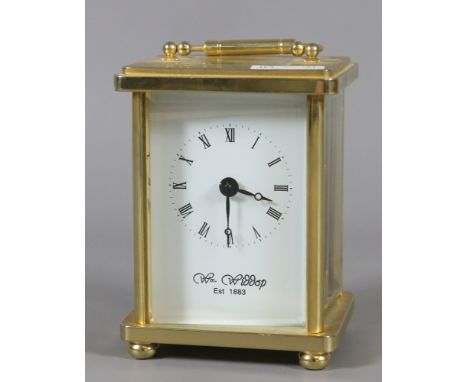 A brass cased carriage clock with white enamel dial.
