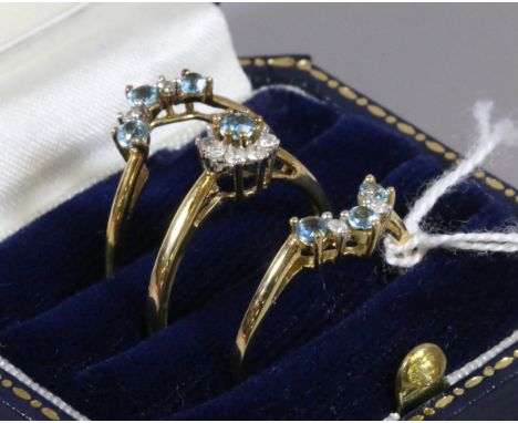 A suite of three 9ct gold rings set with diamonds and blue topaz size R.