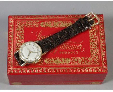 A boxed Longines Wittnauer round face 1950s manual wristwatch 10ct gold filled with centre second and having baton and numera