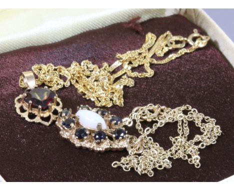 Two 9ct gold pendants on chains one with a single garnet and the other with an opal and onyx.