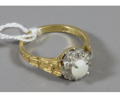 An 18ct gold cluster ring set with a circular opal and diamonds, size O.