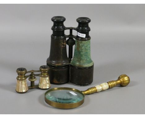A pair of mother of pearl opera glasses along with a pair of field binoculars and brass handled magnifying glass.