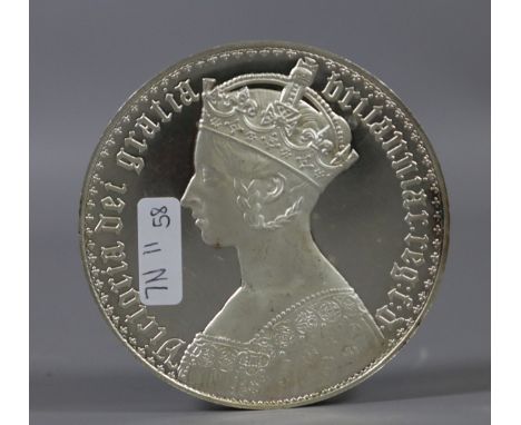 A large white metal commemorative medallion.