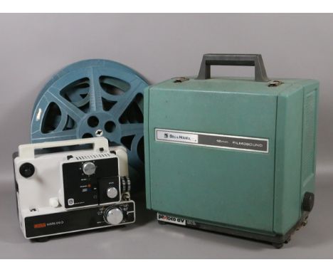 A Eumig projector along with a Bell & Howell 16mm projector and film reels.