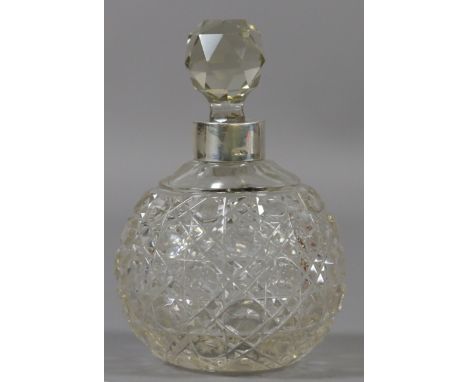 A globular cut glass and silver mounted scent bottle.