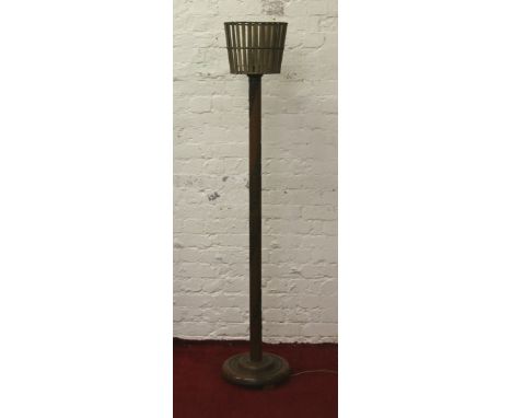 An oriental carved hardwood standard lamp and shade carved with a scrolling landscape scene.