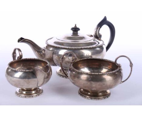 GEORGE V SILVER THREE PIECE TEA SERVICE
maker Walker & Hall, Sheffield 1920, of round form with beaded rims, approximately 90