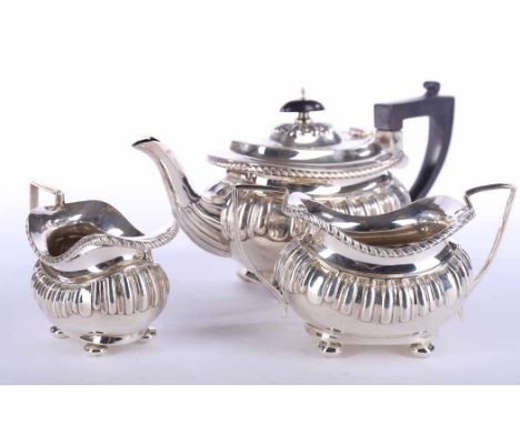 EDWARDIAN SILVER BACHELOR'S THREE PIECE TEA SERVICE
maker Joseph Gloster Ltd, Birmingham 1902, partially gadrooned with reede