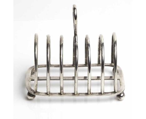 LATE VICTORIAN SILVER SIX SLICE TOAST RACK
maker William Hutton & Sons Ltd, London 1895, with loop handle on four bun feet, a