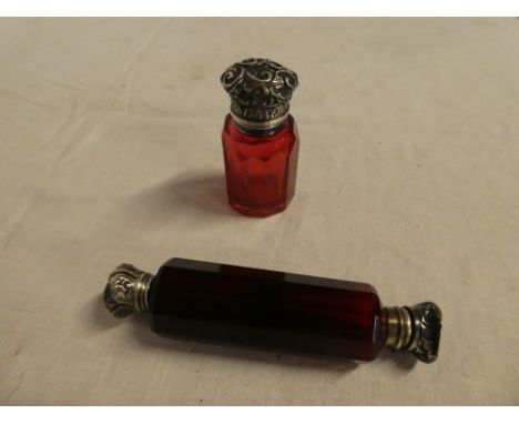 An Edward VII cranberry tinted glass scent bottle with silver mounted hinged lid, Birmingham marks 1902 and a ruby tinted gla