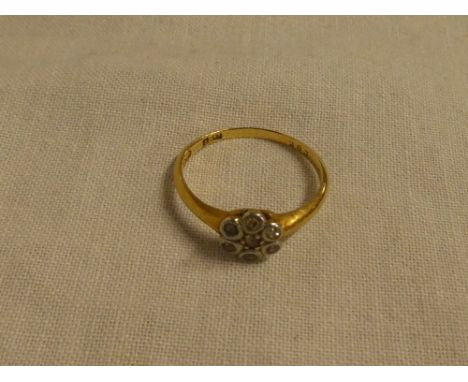 An 18ct gold dress ring with floral mount set diamond chips