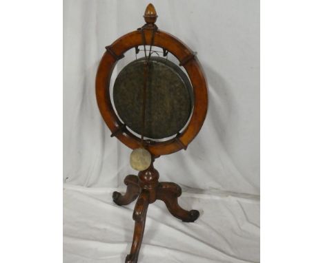 A late Victorian/Edwardian carved oak gong stand of circular form with turned column and carved tripod base with brass gong a