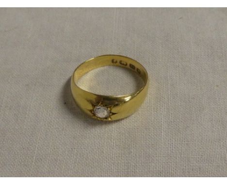 An 18ct gold gypsy-style dress ring set a diamond