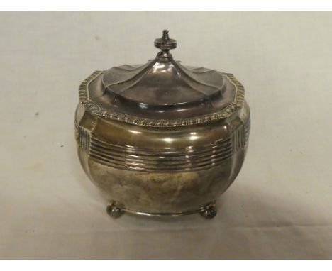 A late Victorian silver shaped-rectangular tea caddy with hinged lid, raised decoration and ball feet, 4" long, London marks,