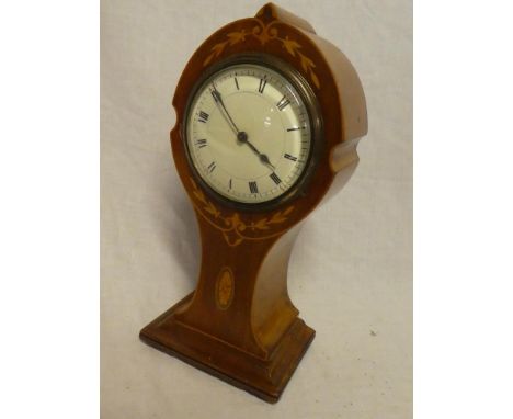 An Art Nouveau mantel clock with circular enamelled dial in inlaid mahogany arched tapered case, 10" high