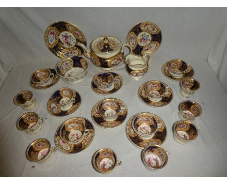 A 19th Century Rockingham china part tea and coffee set comprising circular tea pot and stand with painted floral panels amid