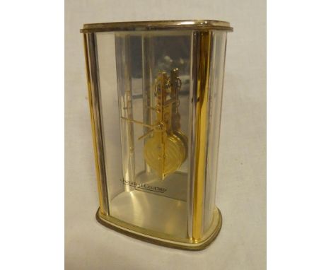 A good quality mantel clock by Jaeger-le Coultre with visible movement and escapement in gilt brass glazed rectangular case 