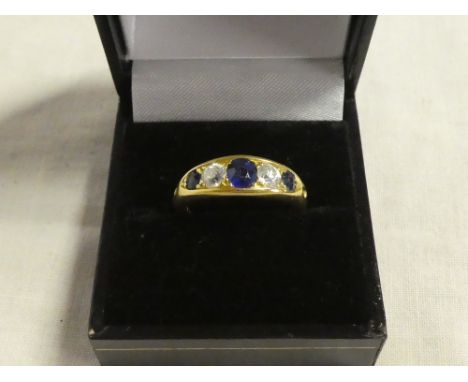 A good quality 18ct gold heavy dress ring set three sapphires and two diamonds