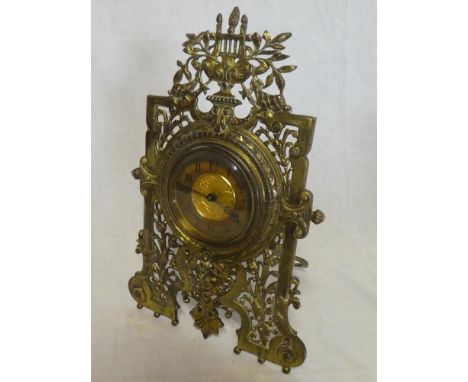 A good quality mantel clock with gilt circular dial in brass relief decorated pierced case 12½" high
