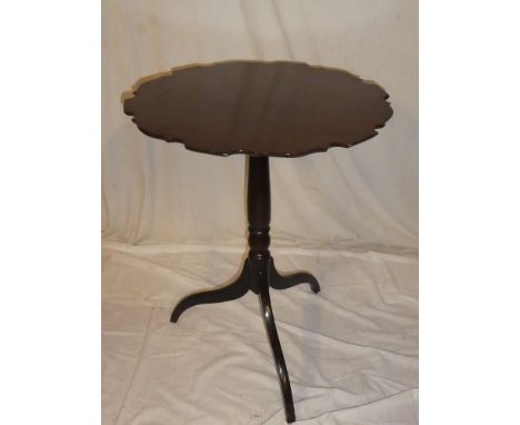 A 19th Century mahogany circular wine table with pie crust top on turned column with tripod base