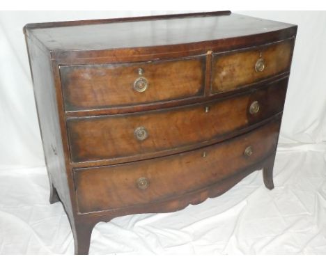 A small mid 19th Century mahogany crossbanded bow-front chest of two short and two long drawers with brass ring handles on br