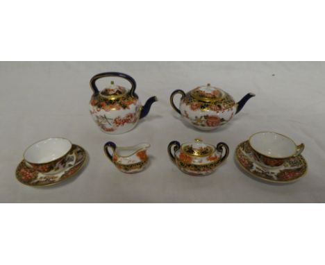 A Royal Crown Derby miniature china tea for two set comprising tea kettle with blue, gilt and red decoration, matching tea po