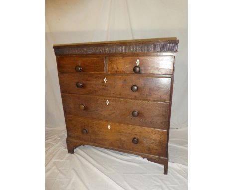 An early 19th Century mahogany chest of two short and three long drawers with turned handles on bracket feet