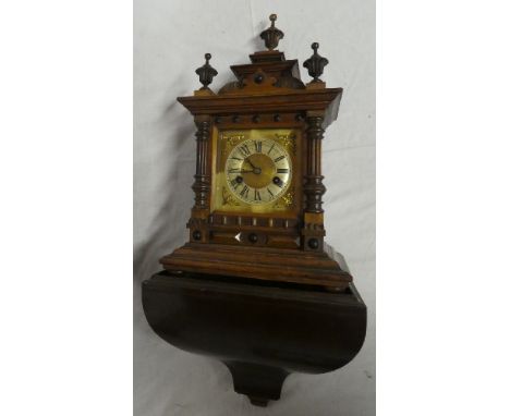 A German bracket clock with brass and silvered square dial in polished walnut rectangular case with fluted columns together w
