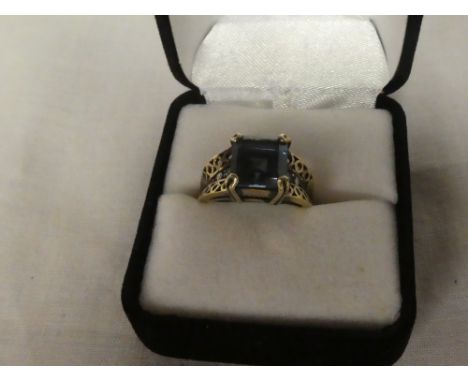 A 9ct gold dress ring set square tourmaline flanked by diamond chips