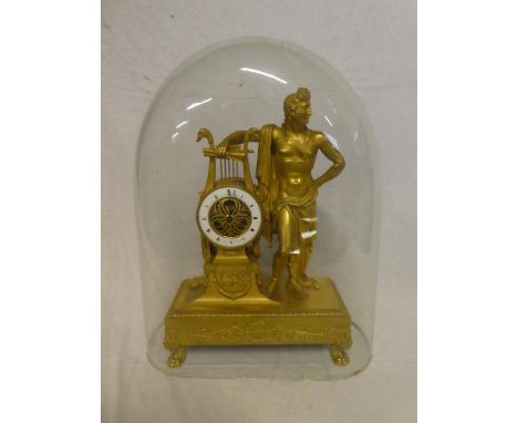 A 19th Century French Empire gilt mantel clock with circular enamelled dial marked "Lepaute H'du L'Empereur" in ornate gilt c