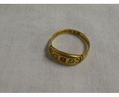 A Victorian 18ct gold dress ring set central ruby flanked by two seed pearls