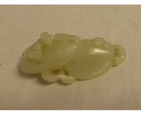 A Chinese carved jade figure of two mushrooms with raised decoration, 3" long