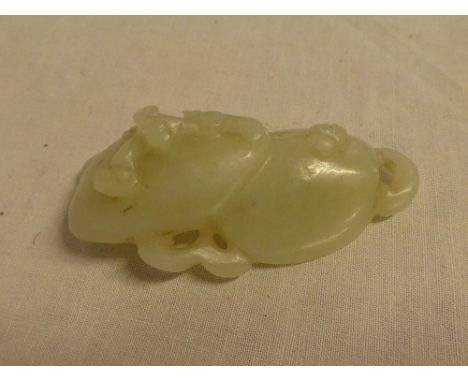 A Chinese carved jade figure of two mushrooms with raised decoration, 3" long