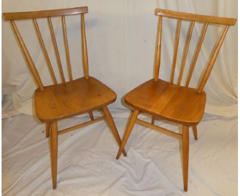 A set of six 1960's Ercol light elm dining chairs with spindle backs and shaped seats on turned legs