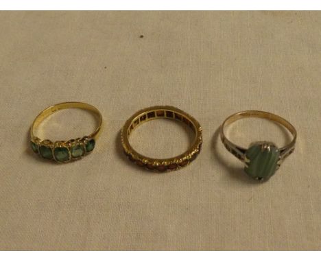 A 9ct gold dress ring set jade, gold dress ring set five green stones and an eternity ring set garnets (3)
