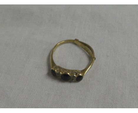 An 18ct gold dress ring set three sapphires and four small diamonds