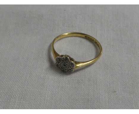 An 18ct gold dress ring set diamond cluster