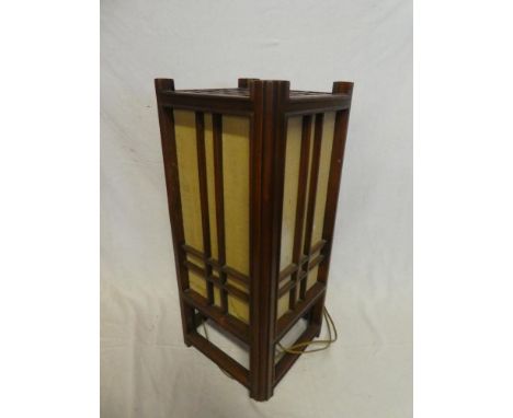 A Chinese mahogany square section floor lamp with fabric lined panels