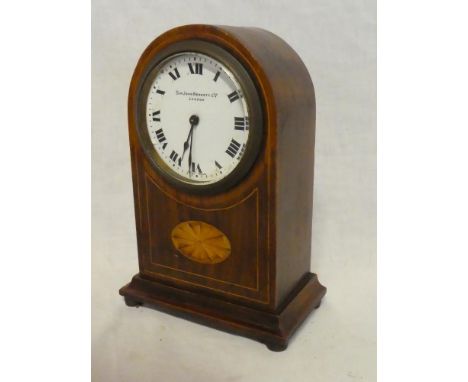 A good quality mantel clock with circular enamelled dial by Sir John Bennett Limited London in inlaid mahogany arched case