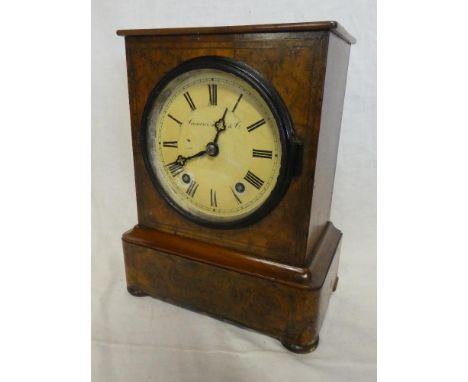An Edwardian mantel clock with painted circular dial by Camerer Cuss &amp; Co in figured walnut rectangular case