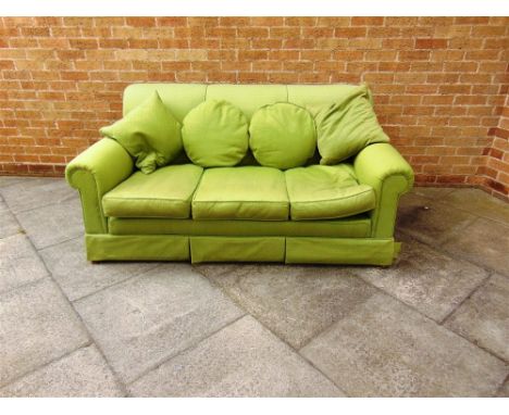 A THREE-SEATER SOFA upholstered in pale green with loose cushions in matching fabric, 180cm wide