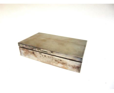 A SILVER CIGARETTE BOX wooden lines, engine turned cover, presentation inscription, 16.5cm long