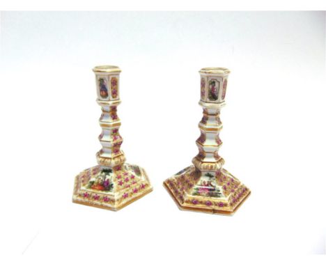 A PAIR OF 'AUGUSTUS REX' HEXAGONAL CANDLESTICKS  with polychrome enamelled decoration of courting couples, 'AR' monogram to b