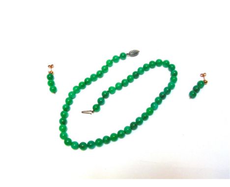A UNIFORM ROW OF JADE BEADS the fifty beads of approximately 8.3mm diameter, to a silver coloured clasp, 44cm long; with a pa